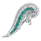 An Art Déco platinum, diamond and emerald brooch. 1935 circa