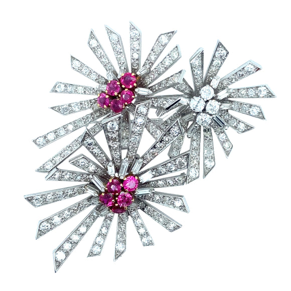 A platinum diamond and ruby flower brooch. 1940.