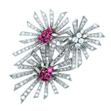 A platinum diamond and ruby flower brooch. 1940.