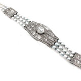 An Edwardian platinum, diamond and natural pearls bracelet