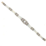 An Edwardian platinum, diamond and natural pearls bracelet